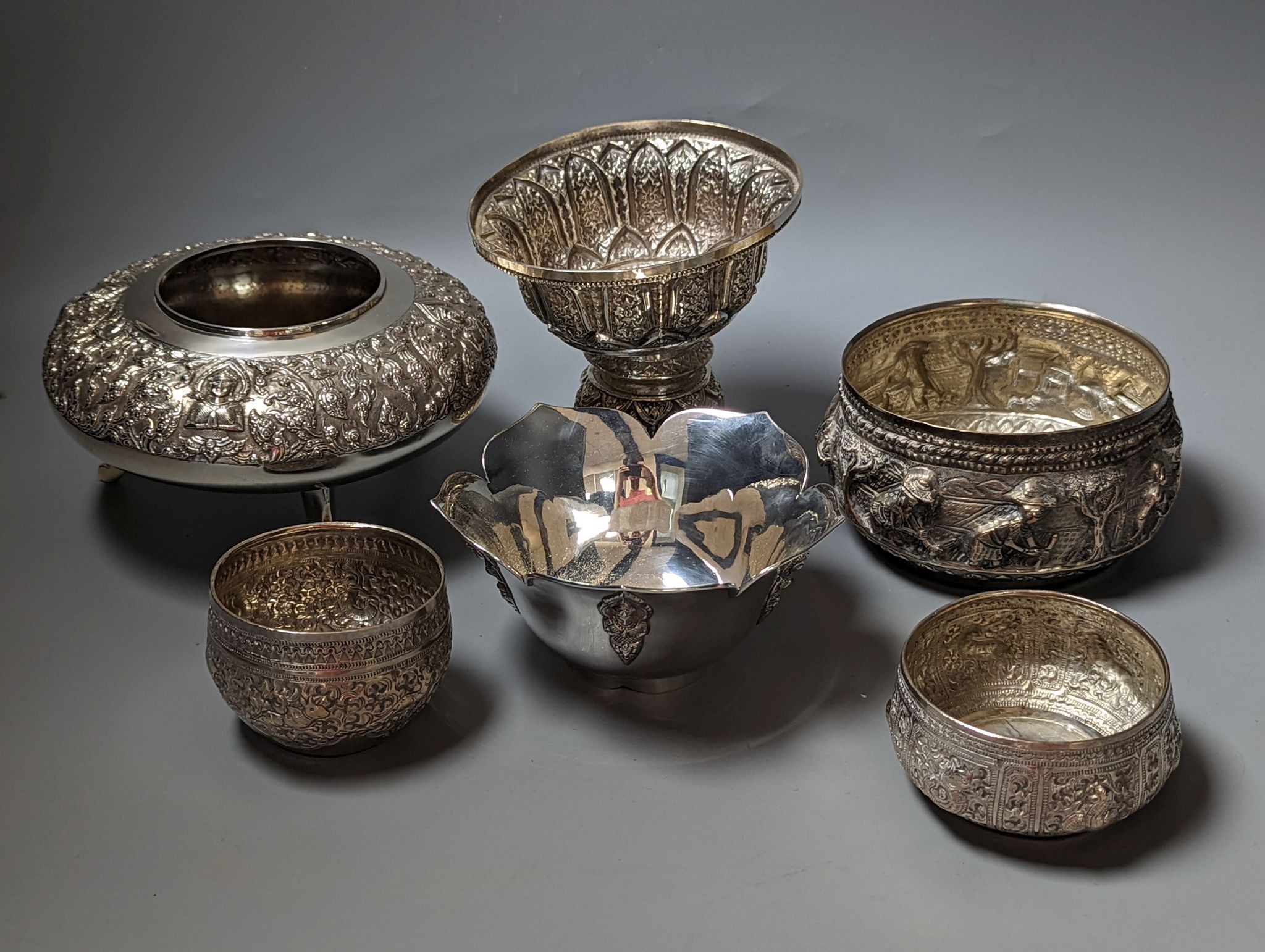 Six assorted embossed white metal bowls, including Indian and Thai, tallest 13.6cm.